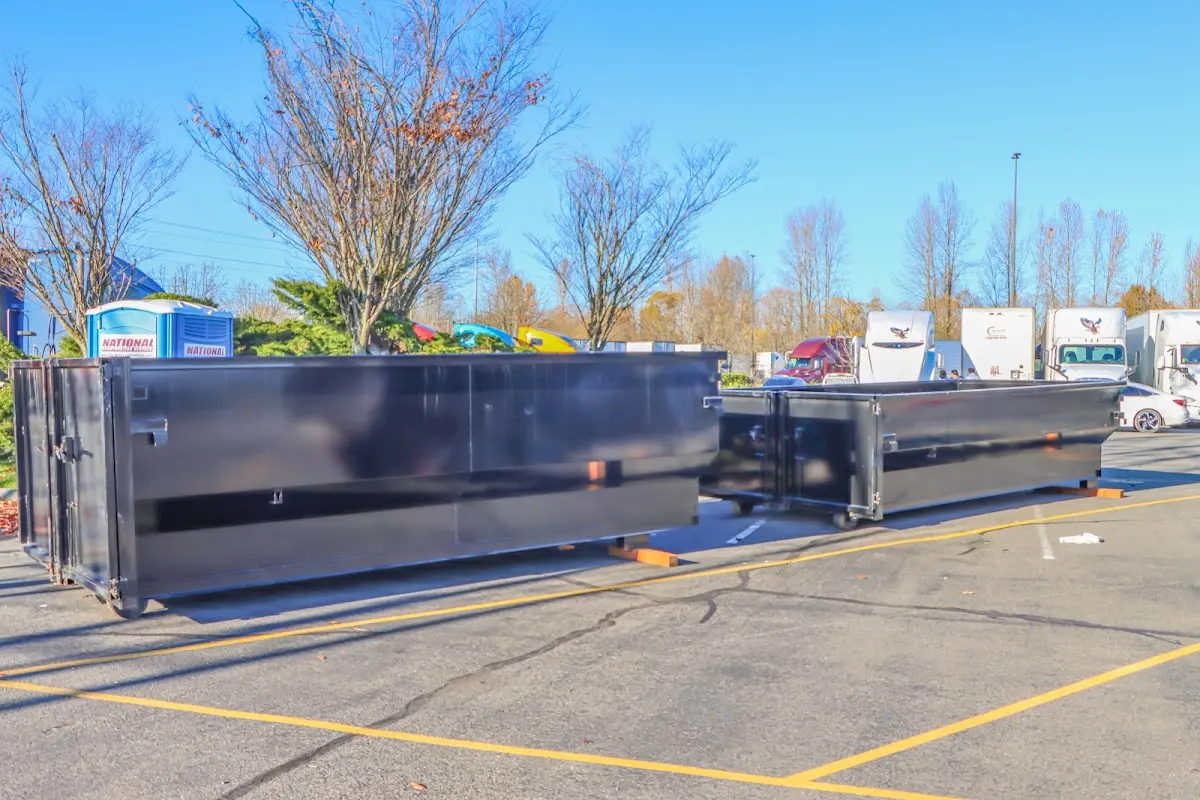 Professional dumpster rental service with roll-off container on residential driveway in Flagler Beach
